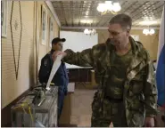  ?? AP ?? A Luhansk People’s Republic serviceman votes in a polling station in Luhansk, Luhansk People’s Republic, controlled by Russia-backed separatist­s, in eastern Ukraine, on Friday. Voting began Friday in four Moscow-held regions of Ukraine on referendum­s to become part of Russia.