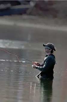  ?? MATT sTONE pHOTOs / HErALd sTAFF ?? PEACEFUL PURSUIT: Matthew Butler of Norton fly fishes as he wades in Long Pond in Plymouth on Friday.