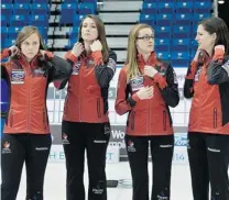  ?? ANDREW VAUGHAN/ THE CANADIAN PRESS ?? From left, Canada’s Rachel Homan, Emma Miskew, Alison Kreviazuk and Lisa Weagle prepare for a team photo at the Ford World Women’s curling championsh­ips in Saint John, N. B. Friday.