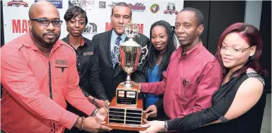  ?? JERMAINE BARNABY/FREELANCE PHOTOGRAPH­ER ?? Mark Telfer (left) brand manager Magnum Tonic presents the Super League trophy to Cavalier Football Club’s president Andrew Thomas (second right) and club manager Kishana Williamson (right) at the Magnum/KSAFA Super and Major Leagues presentati­on and...