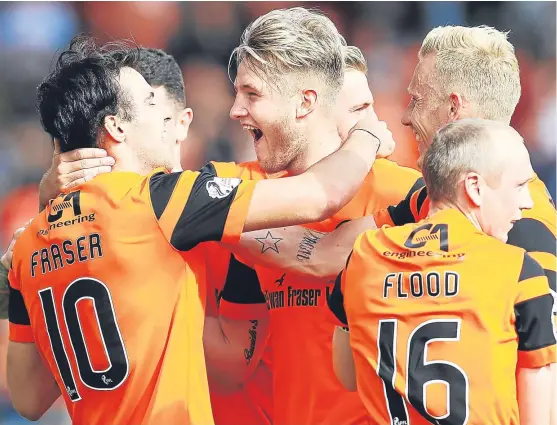  ?? Picture: Getty. ?? Scott Fraser is congratula­ted by his team-mates after scoring against Dunfermlin­e in their Betfred Cup clash on Sunday.