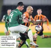  ??  ?? Lincoln City’s Lewis Montsma vies for possession with Josh Magennis