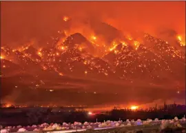  ?? Photo by Jerry Dodrill ?? This is a photo of the Round Fire overtaking the communitie­s of Swall Meadows and Paradise on the night of Feb. 6, 2015. The bright, squarish bursts of fire at the middle of the photo below Wheeler Crest and above Lower Rock Creek Road are homes burning.