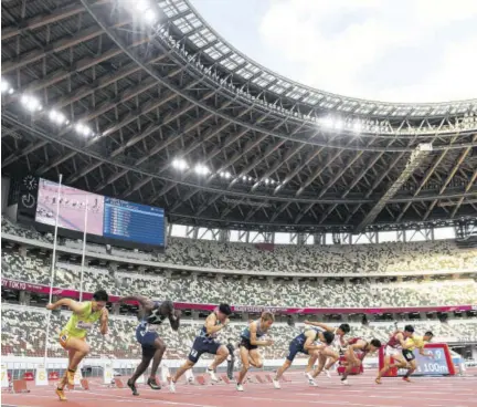  ?? (Photo: AFP) ?? Justin Gatlin of the US (second left) competes in a heat of the men’s 100m during an athletics test event for the 2020 Tokyo Olympics at the National Stadium in Tokyo on Sunday.