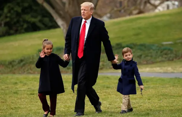  ??  ?? RESTRAINED: People need to remember that US President Donald Trump, pictured here holding hands with his grandchild­ren Arabella and Joseph outside the White House, has to act within the boundaries of the American constituti­on. Photo: Reuters/Kevin...