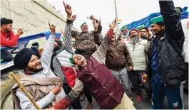  ?? — PTI ?? Farmers dance at Ghazipur border in New Delhi on Monday.