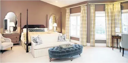  ?? JEN RYNDA/BALTIMORE SUN MEDIA GROUP PHOTOS ?? Designer Elizabeth Reich chose a dark beige for the wall and updated the bed linens to make the master bedroom feel more intimate.