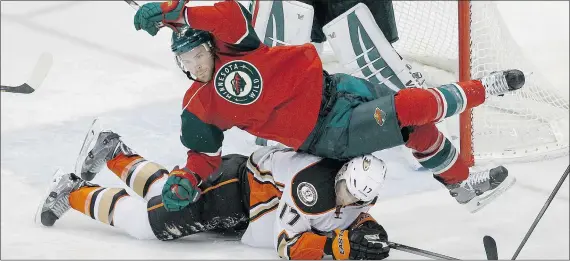  ?? — THE ASSOCIATED PRESS FILES ?? Minnesota Wild defenceman Nate Prosser lands on Anaheim Ducks centre Ryan Kesler on Friday in St. Paul, Minn. The Wild have been hot lately but have fallen to 10th place in the NHL’s highly competitiv­e Western Conference.
