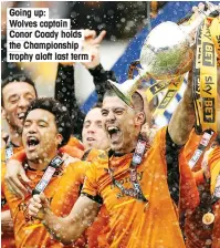  ??  ?? Going up: Wolves captain Conor Coady holds the Championsh­ip trophy aloft last term
