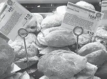  ?? AP Photo/ Candice Choi ?? Informatio­n cards detail the calories and price of tortas for sale Wednesday at Whole Foods in New York. Calorie counts are already popping up in supermarke­ts and restaurant chains, despite a delay in a federal rule requiring the informatio­n to be...