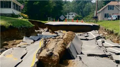  ?? PAUL LAROCHELLE ?? Flooding in mid-July washed away a section of a road in Alton. The National Oceanic and Atmospheri­c Administra­tion reports June and July were the rainiest since 1885.