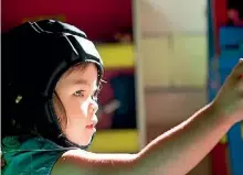  ?? TOM LEE/STUFF ?? Two-year-old Haven Holley with her special helmet on.