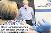  ??  ?? Boris Johnson watches Lyn Wheeler get her jab