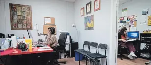  ?? DARRYL DYCK THE CANADIAN PRESS ?? Crisis line volunteers Shoak Alhussami, left, and Dyalla Popatia work at Battered Women's Support Services in Vancouver, where the severity of many callers’ situations have intensifie­d.