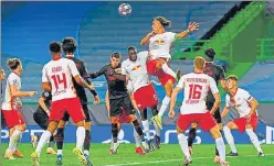  ??  ?? Yussuf Poulsen (top) of RB Leipzig heads the ball during their Champions League quarter-final against Atletico Madrid in Lisbon on Thursday. Leipzig won 2-1 in the second leg.