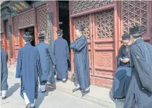  ??  ?? KEEPING RELIGION: Taoist priests at the White Cloud Temple, the centre of China’s indigenous faith, above.