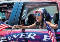  ?? TERRY PIERSON — STAFF PHOTOGRAPH­ER ?? A girl yells holiday wishes to onlookers from a truck in the parade along Bonita Avenue during La Verne’s “United We Stand” Fourth of July celebratio­n on Saturday.
