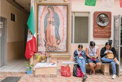  ?? Karen Castaneda/Associated Press ?? Migrants use their phones on Sept. 26 at Casa del Migrante Catholic refugee shelter in Tijuana, Mexico.