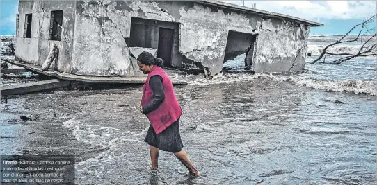  ?? EL PAÍS ?? Drama. Bárbara Cardosa camina junto a las viviendas destruidas por el mar. En poco tiempo el mar se llevó las filas de casas.