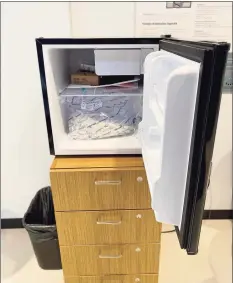  ?? Photo courtesy of Meg Barry / UConn ?? A refrigerat­or in UConn’s Engineerin­g and Science Building on campus is filled with bags containing hundreds of vials of saliva. The vials are sent for COVID- 19 testing every day.