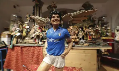  ?? Photograph: Salvatore Laporta/AP ?? A statuette by artist Genny Di Virgilio portraying Diego Maradona with angel’s wings next to a nativity scene in his shop in Naples, Italy.
