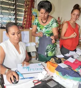  ?? Photo: Jyoti Pratibha ?? Busy at work, from right: Cathy Petersen, her aunt Karolina Waqa and sister Davina Hennings sorting orders for her online shopping page on Facebook.