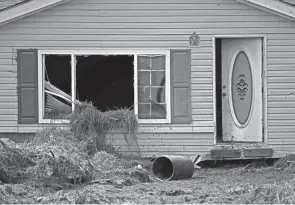  ?? PHOTOS BY GERALD HERBERT/AP ?? A month after Hurricane Ida, small communitie­s like Ironton along Louisiana’s southeaste­rn coast are still without power or running water. Some residents lost most of their possession­s to floodwater­s.