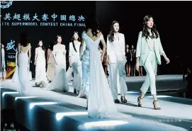  ??  ?? Leona Fu (front) attends the China event of an internatio­nal super model contest, where she was runner-up in the final.