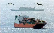  ?? PHOTO: REUTERS ?? Australian special force soldiers (foreground) ride their inflatable boat past the Norwegian freighter Tampa off Christmas Island in August 2001.