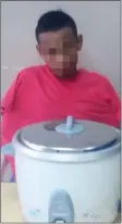  ??  ?? The suspect and the seized rice cooker brought to the Bau District Police Headquarte­rs.