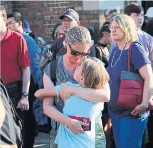  ?? RENÉ JOHNSTON PHOTOS/TORONTO STAR ?? A woman hugs a child where the march started at 60 Bowden St. Mayor John Tory and Premier Doug Ford attended the vigil as thousands gathered to support and comfort the community.