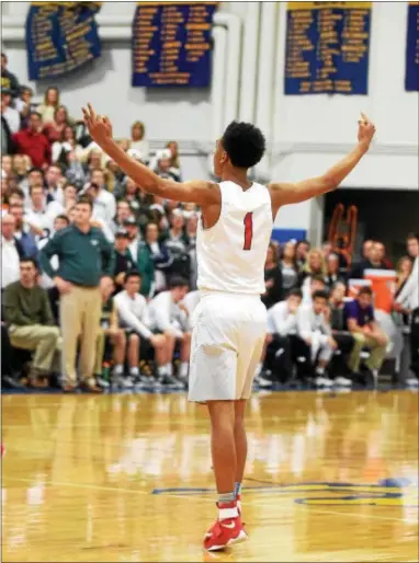  ?? PETE BANNAN — DIGITAL FIRST MEDIA ?? Coatesvill­e’s Hassan Young celebrates a critical 3-point basket in overtime as the Red Raiders defeated Bishop Shanahan, 43-37, to win their second straight Ches-Mont League Championsh­ip Thursday night at Downingtow­n West.