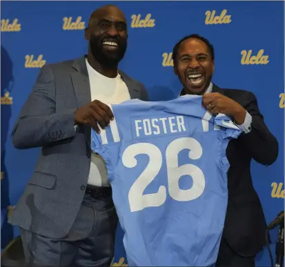  ?? DAMIAN DOVARGANES — THE ASSOCIATED PRESS ?? New UCLA football coach Deshaun Foster, left, poses with Athletic Director Martin Jarmond during Tuesday’s introducto­ry press conference.