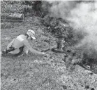  ??  ?? A Hawaii Volcano Observator­y geologist collects samples of spatter for laboratory analysis in the Leilani Estates subdivisio­n near Pahoa on the Big Island of Hawaii.