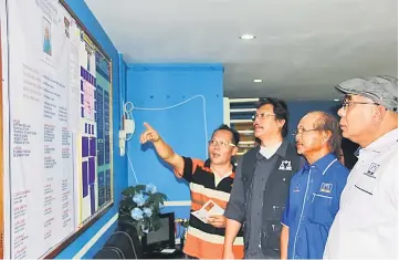  ??  ?? (From left) PBB Tanjong Datu Youth chief Jamsari Ahamad is seen giving a briefing to Dr Hazland, John and political secretary to the chief minister Buang Bolhassan at the operations room in Lundu.