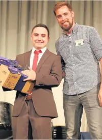  ??  ?? ●●Shaun Brady receives his prize for 100 per cent attendance from guest speaker Ben Smith