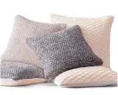  ??  ?? Soft wools like pillow covers at Restoratio­n Hardware are part of the hygge vibe.