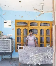  ?? NITIN KANOTRA / HT ?? A border villager removes the broken glass of a building damaged during shelling from the Pakistani side in Nanga village of Ramgarh sector in Jammu on Wednesday.