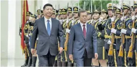 ??  ?? Chinese President Xi Jinping (left) holds a welcome ceremony for President Moon Jae-in of the Republic of Korea (ROK).