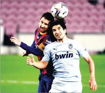  ?? AFP ?? Barcelona’s Argentinia­n forward Lionel Messi (left) vies with Valencia’s Spanish midfielder Carlos Soler during the Spanish league football match at the Camp Nou stadium in Barcelona on Saturday.