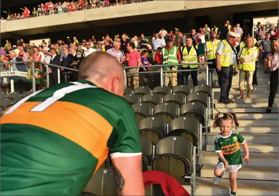  ??  ?? Kerry’s Kieran Donaghy’s daughter Lola Rose joins him on the pitch following the Kingdom’s 80th Munster senior football title on Saturday evening in Páirc Uí Chaoimh Photo by Éoin Noonan / Sportsfile