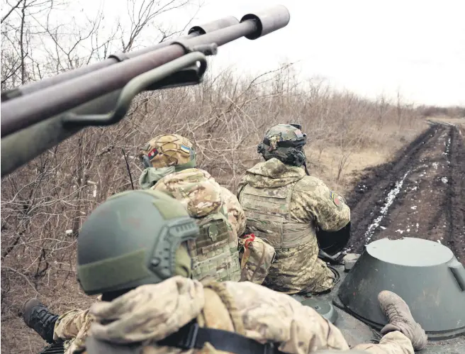  ?? EDITOR BURCU BAŞARAN ?? Ukrainian anti-aircraft gunners of the 93rd Separate Mechanized Brigade Kholodny Yar move to their position in the Bakhmut direction in the Donetsk region, Ukraine, Feb. 20, 2024.