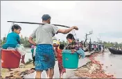  ?? AFP ?? A Rohingya refugee carries two children in buckets.