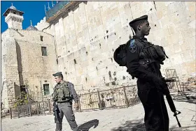  ?? AP/BERNAT ARMANGUE ?? Israeli border police stand guard on the site known to Jews as the Tomb of the Patriarchs in the West Bank city of Hebron in 2013.