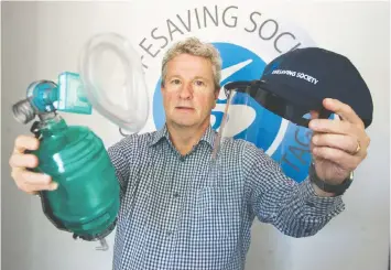  ?? — JASON PAYNE ?? Dale Miller, executive director of the Lifesaving Society, displays new equipment for lifeguards who will be working amid the threat of virus transmissi­on.