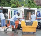  ?? J. SCOTT APPLEWHITE/AP ?? Letter carriers load trucks with mail to be delivered at a U.S. Postal Service facility in McLean, Va., on July 31. Many voters may decide to cast their ballots in November by mail rather than risk exposure to the coronaviru­s.
