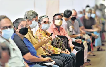  ??  ?? Senior citizens sit in a queue to get inoculated at Mahim Church Vaccinatio­n Centre, on Thursday.