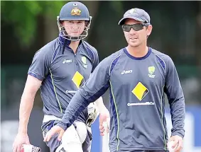  ??  ?? Justin Langer (right) walks with captain George Bailey during an ICC Twenty20 Cricket World Cup practise session ahead of their semi-final match against West Indies in Colombo in this Oct 4, 2012 file photo. — AFP photo