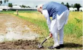  ?? — PTI ?? PM Narendra Modi breaks ground for resilient rice field laboratory, at the Internatio­nal Rice Research Institute, in Los Banos, Philippine­s on Monday.