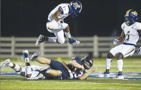  ?? (NWA Democrat-Gazette/Charlie Kaijo) ?? Springdale Har-Ber fullback Warren Hall (center, on ground) carries the ball Friday during a football game against North Little Rock at Springdale Har-Ber High School in Springdale. North Little Rock won 41-28. Check out nwaonline.com/200905Dail­y/ for today’s photo gallery.